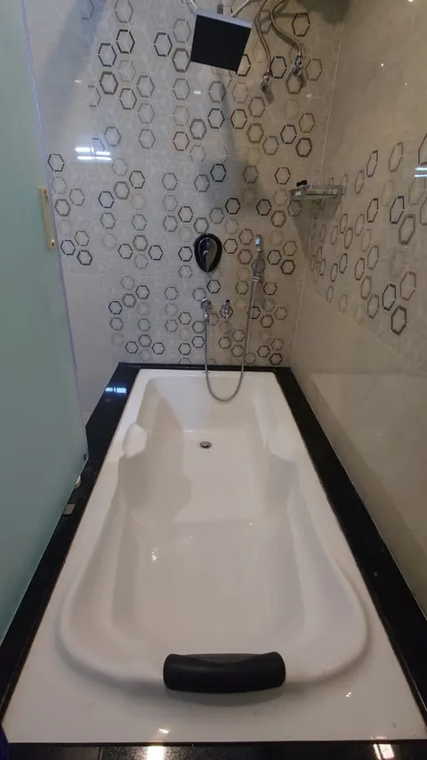 Bathroom with bathtub and rain shower