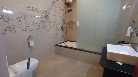 Bathroom with tub and glass partition
