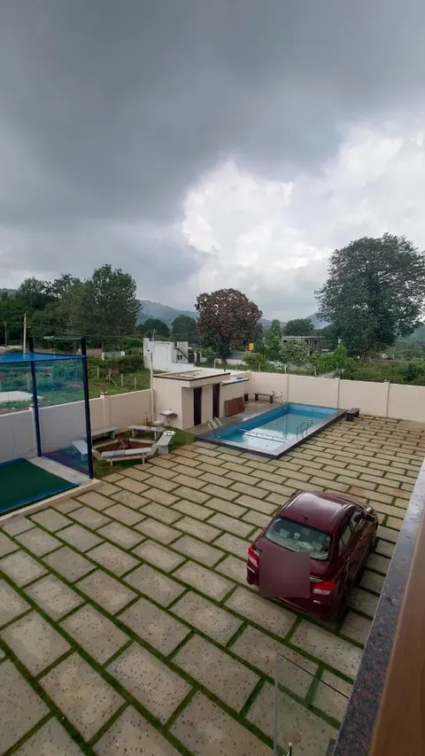 Aerial view of the pool, bonfire area and cricket net