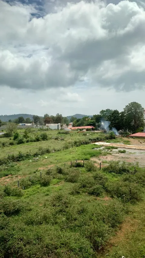Green hillside and clouds seen from the resort